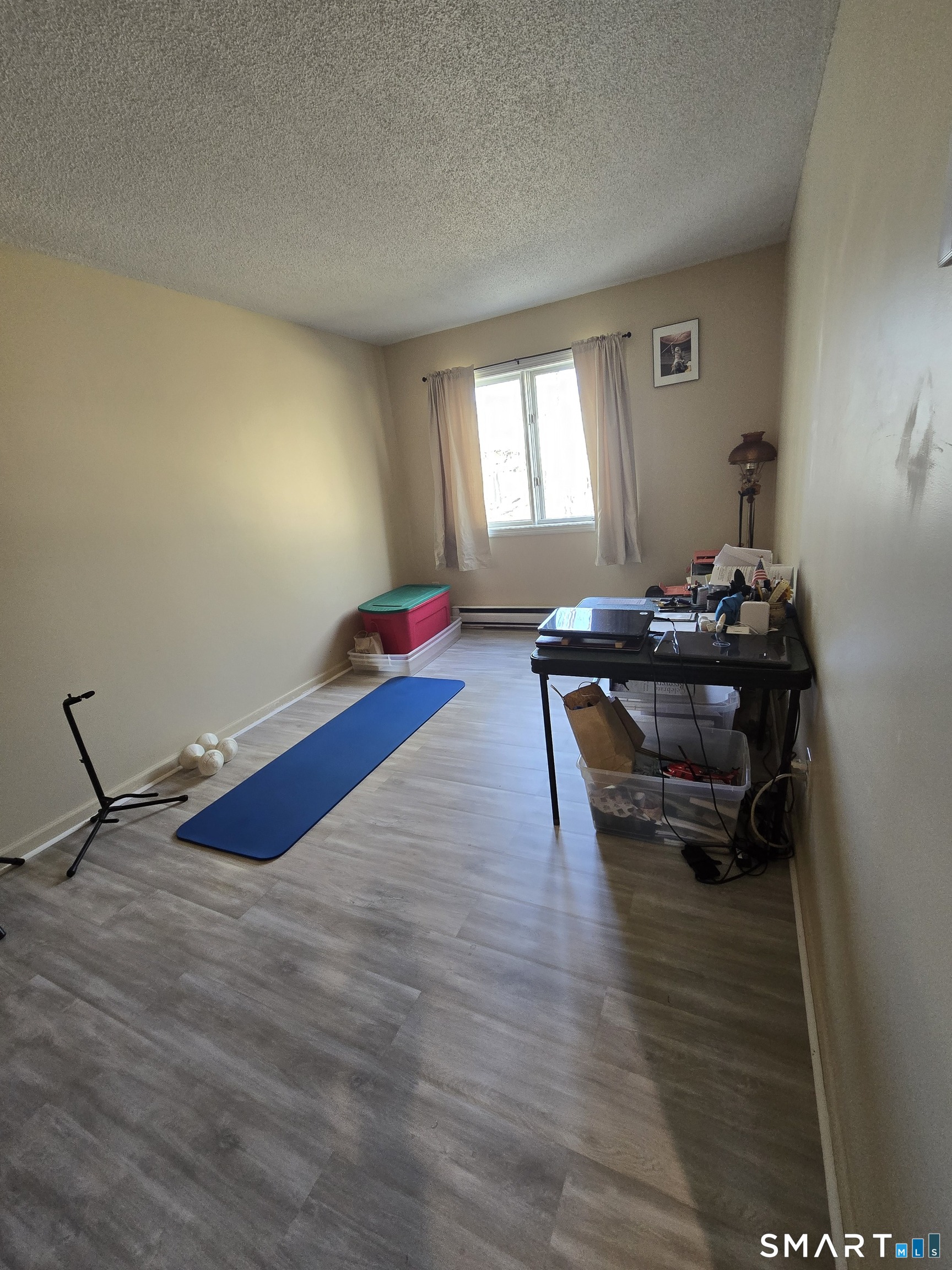 177 Lisle Street, Unit 5 Torrington, CT 06790 - Photo 8 of 18 a room with wooden floor and furniture