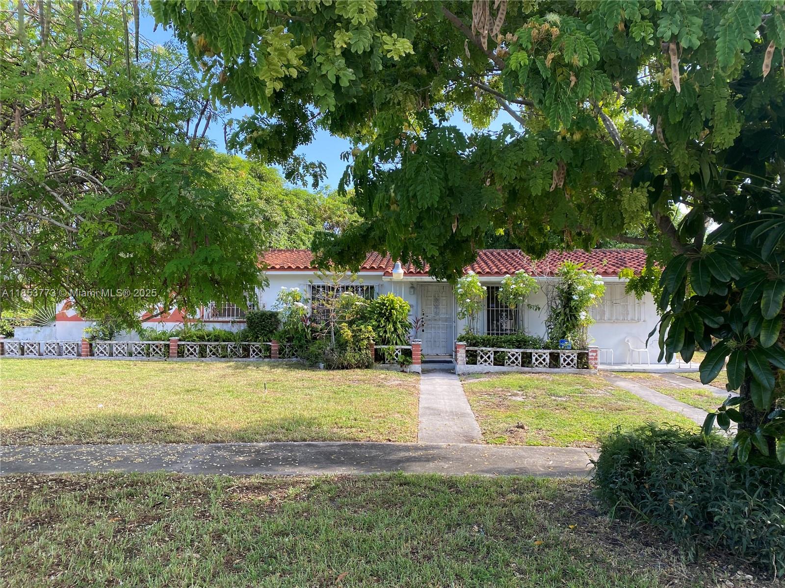 8120 Southwest 10th Terrace Miami, FL 33144 - Photo 1 of 12 a view of a swimming pool and trees in the background