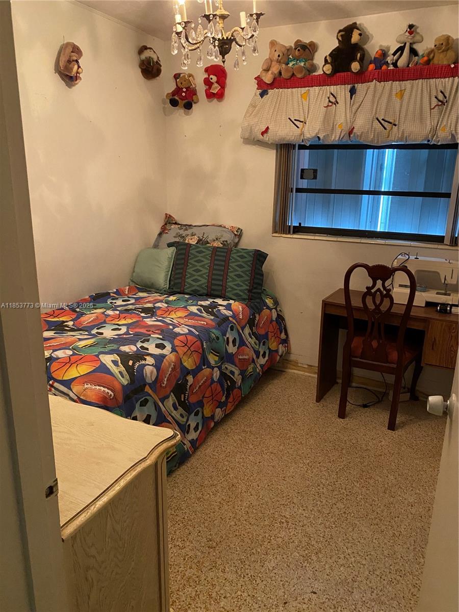 8120 Southwest 10th Terrace Miami, FL 33144 - Photo 12 of 12 a bedroom with a bed and a chair