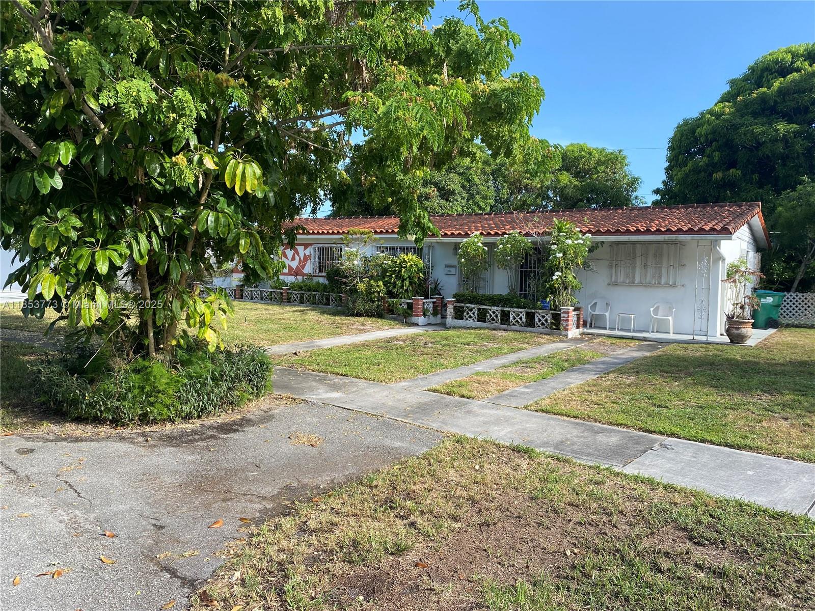 8120 Southwest 10th Terrace Miami, FL 33144 - Photo 3 of 12 a view of a house with a yard