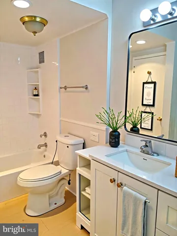 a bathroom with a toilet a sink and a mirror