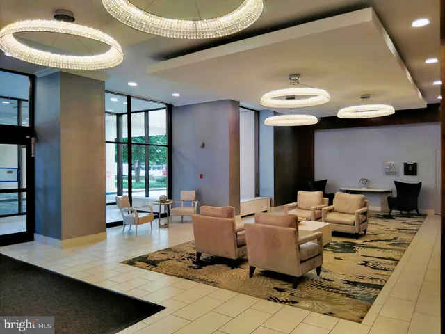 a living room with furniture a window and a potted plant