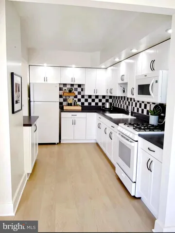 a kitchen with stainless steel appliances a sink and a refrigerator