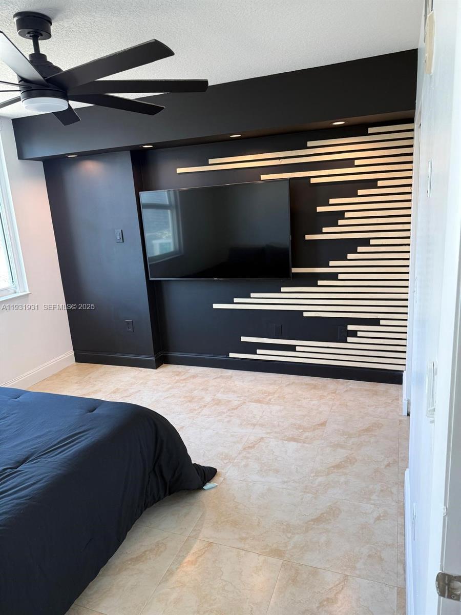 31 Southeast 5th Street, Unit 2907 Miami, FL 33131 - Photo 14 of 38 a bedroom with a bed and a flat screen tv