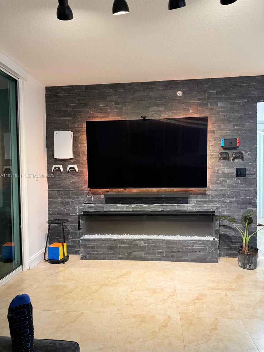 31 Southeast 5th Street, Unit 2907 Miami, FL 33131 - Photo 2 of 38 a living room with fireplace furniture and a flat screen tv