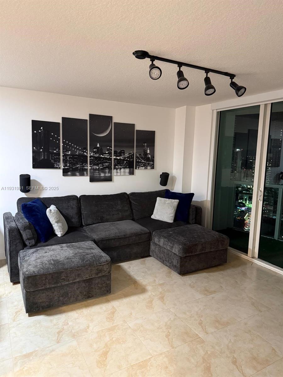 31 Southeast 5th Street, Unit 2907 Miami, FL 33131 - Photo 3 of 38 a living room with furniture and a large window