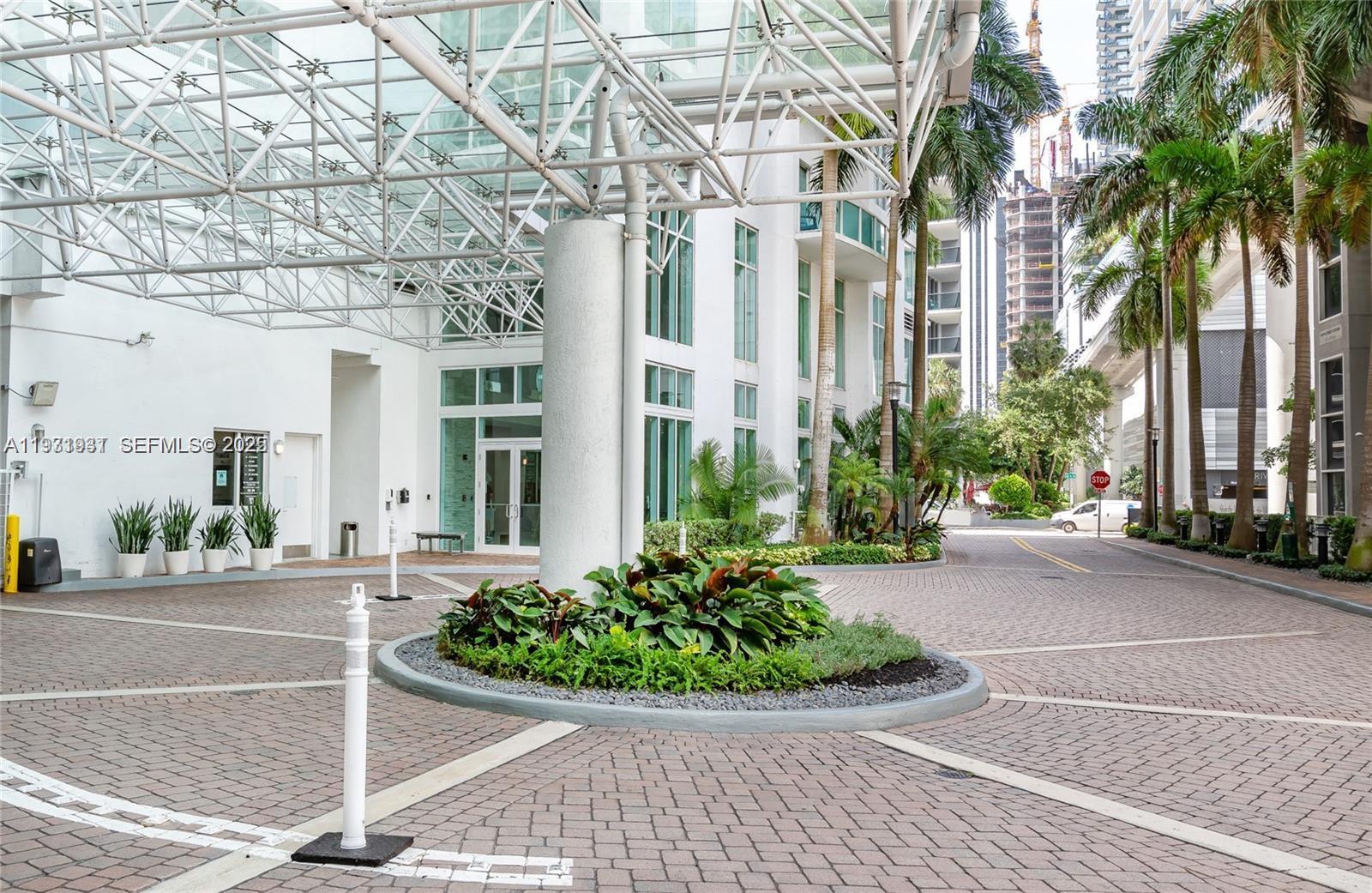 31 Southeast 5th Street, Unit 2907 Miami, FL 33131 - Photo 31 of 38 a view of a building with a yard and potted plants