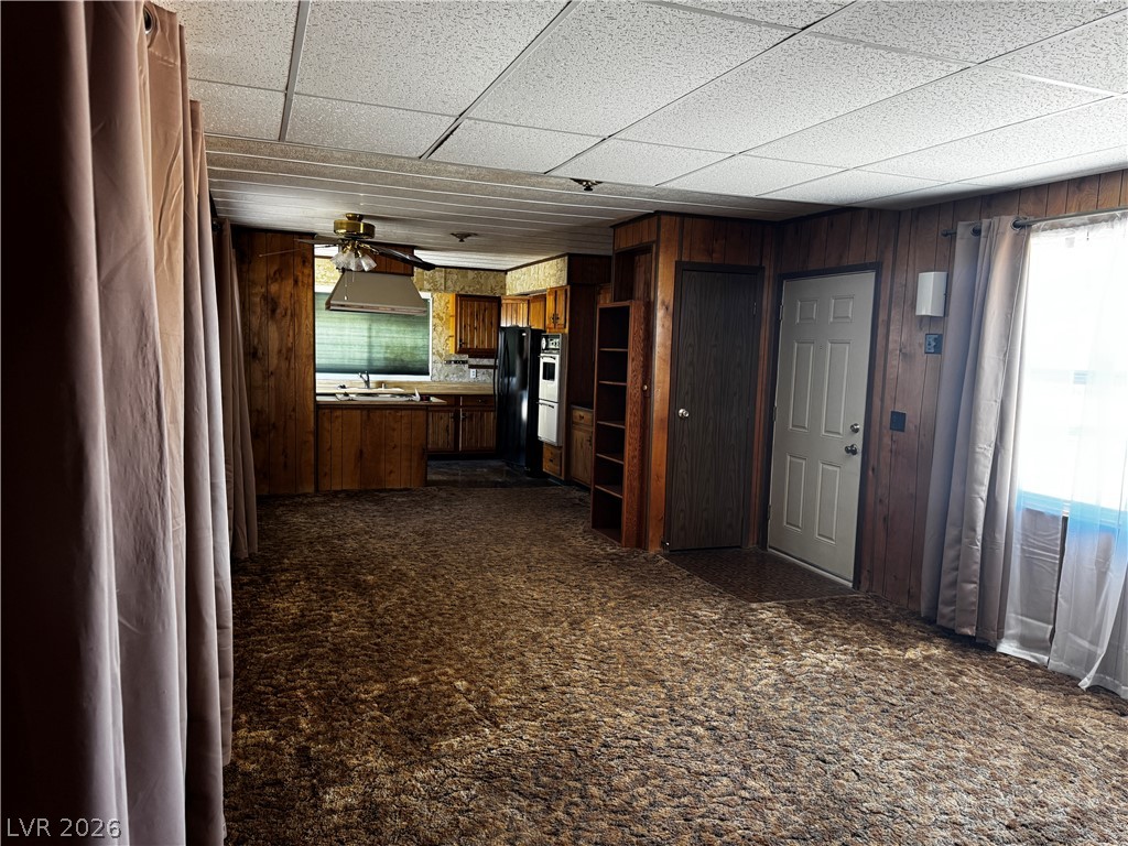 3090 Gally Road Pahrump, NV 89060 - Photo 15 of 20 A well-lit interior reveals a functional kitchen with warm wooden cabinetry and a comfortable living area.