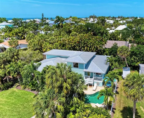 an aerial view of a house with yard and outdoor seating