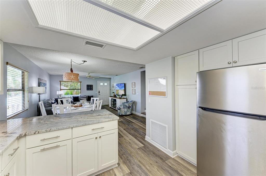 304 74th Street, Unit B Holmes Beach, FL 34217 - Photo 14 of 34 a kitchen with sink refrigerator and cabinets