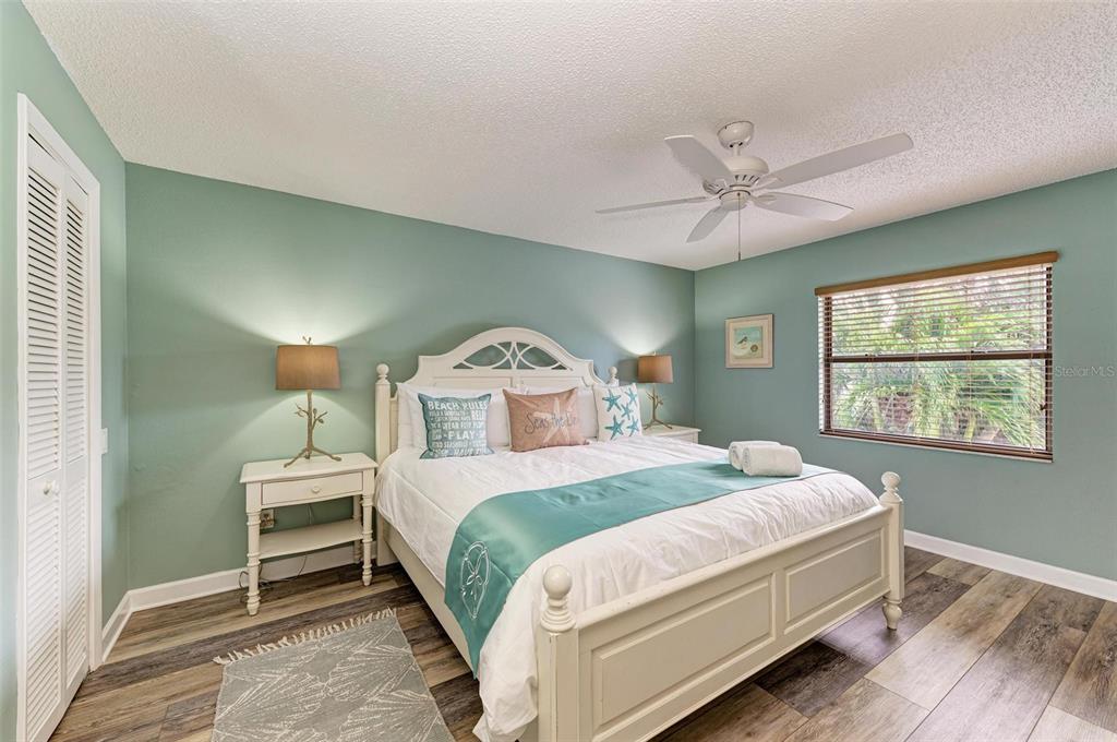304 74th Street, Unit B Holmes Beach, FL 34217 - Photo 20 of 34 a bedroom with a bed and a window