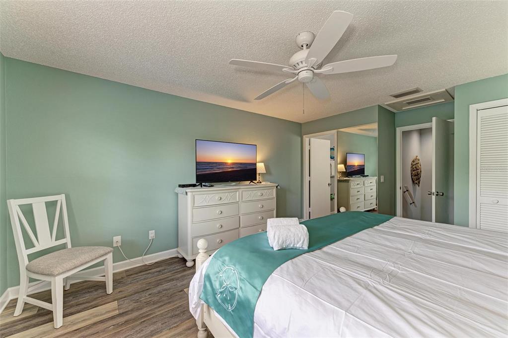304 74th Street, Unit B Holmes Beach, FL 34217 - Photo 21 of 34 a bedroom with a bed and a flat screen tv