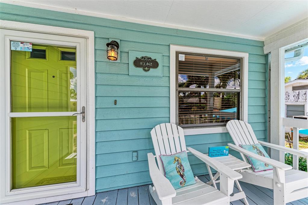 304 74th Street, Unit B Holmes Beach, FL 34217 - Photo 24 of 34 a view of a door and chair in the room