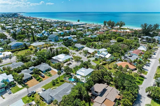an aerial view of residential houses with outdoor space