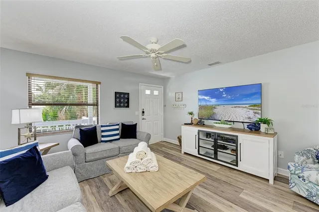 a living room with furniture a fireplace and a table