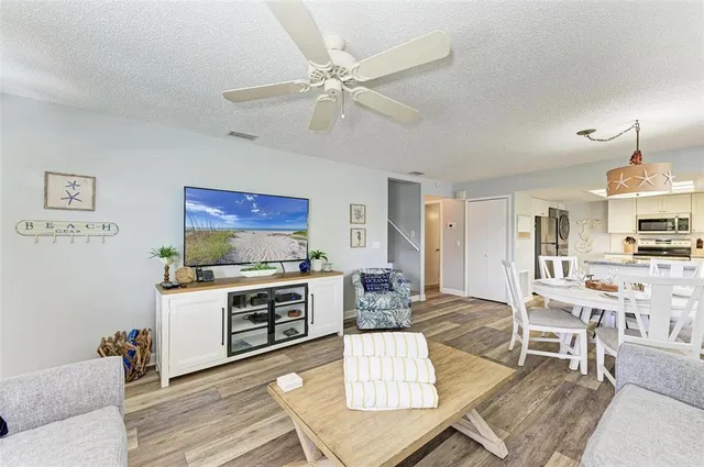 a living room with furniture a dining table and kitchen view