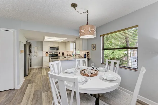 a view of a dining room with furniture window and wooden floor