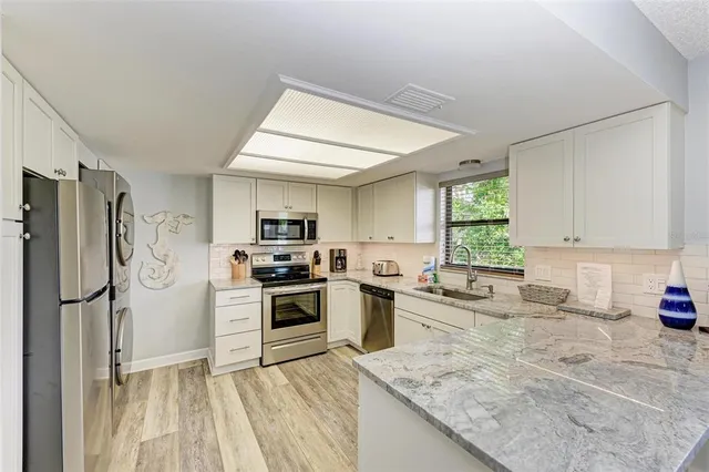 a kitchen with a refrigerator stove and sink