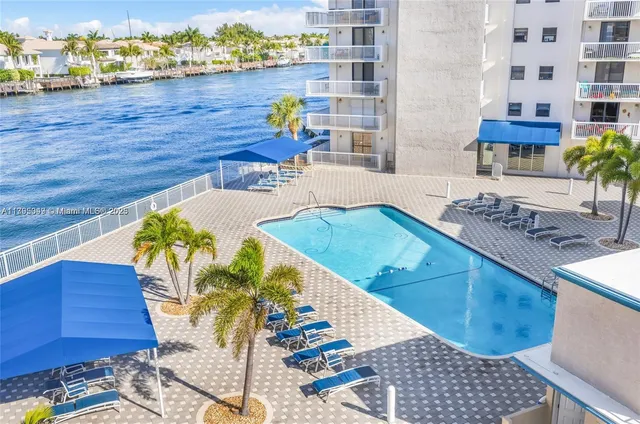 a view of a swimming pool with outdoor seating