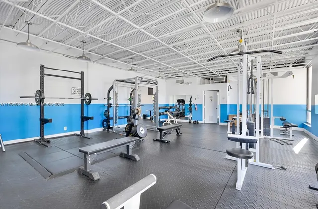 a gym room with lots of gym equipment