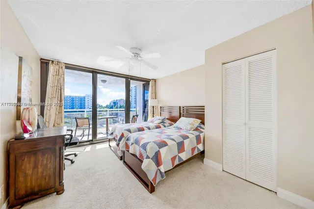 a bedroom with a bed and large window