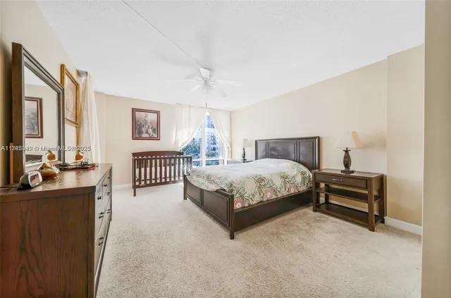 a bedroom with a bed and a dresser with mirror