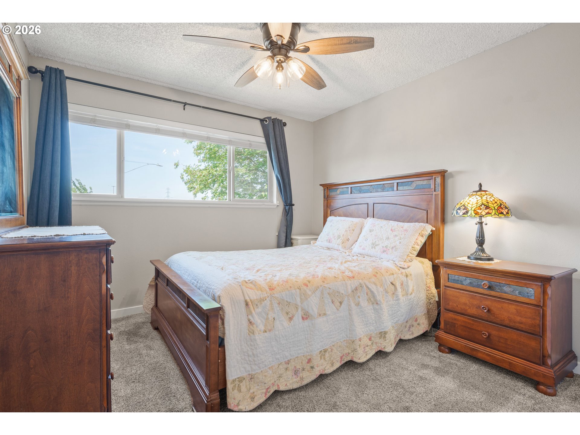 2727 Gateway Street, Unit 18 Springfield, OR 97477 - Photo 18 of 34 a bedroom with a bed and a chandelier