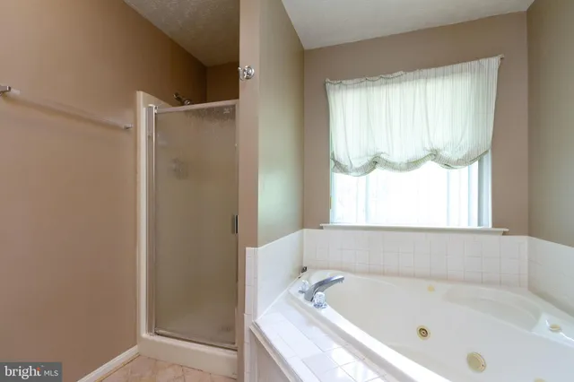 a bathroom with a tub and a shower