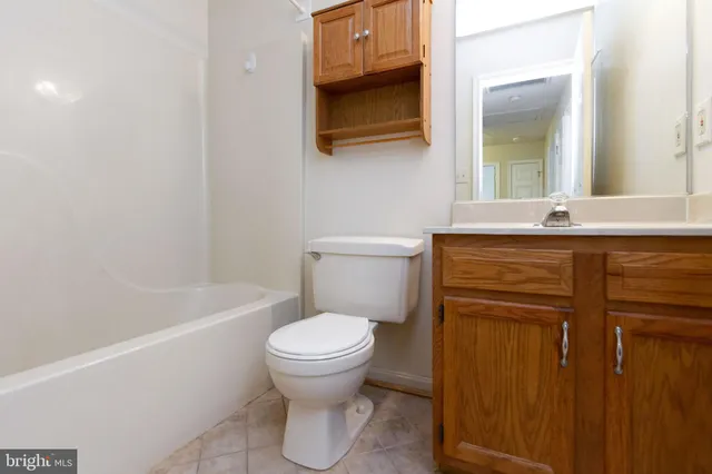 a bathroom with a sink a toilet and bathtub