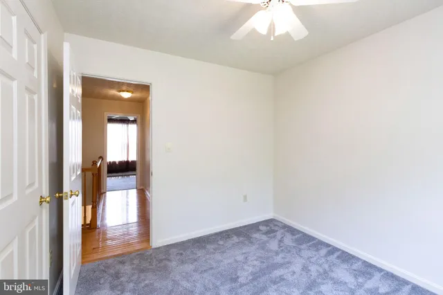 an empty room with an entryway and a hallway