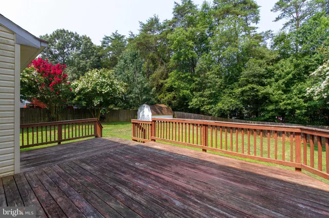 a view of a house with a wooden deck
