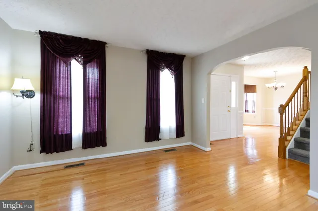a view of a room with wooden floor and a fireplace