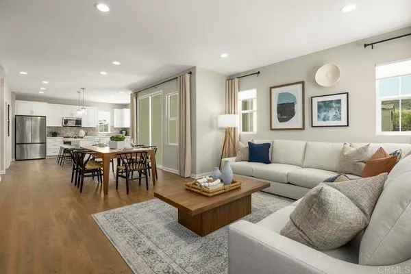 a living room with furniture kitchen and a table