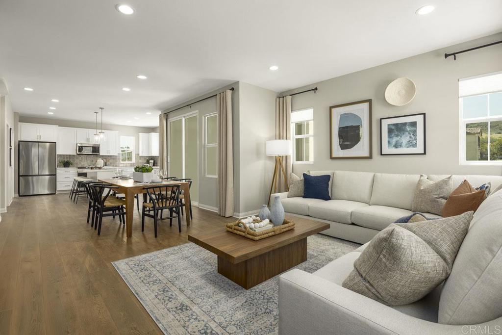 a living room with furniture kitchen and a table