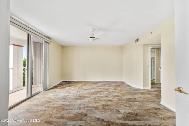 a view of an empty room with glass door