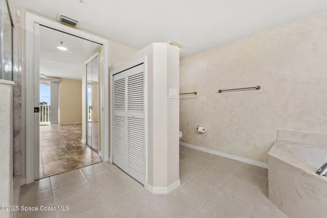 a spacious bathroom with a double vanity sink mirror and double