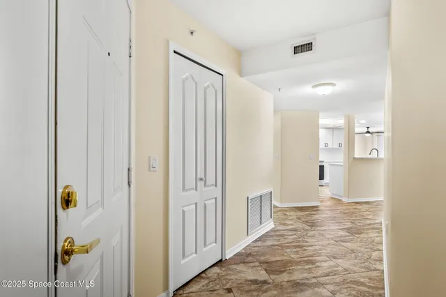 a open kitchen with white cabinets and stainless steel appliances