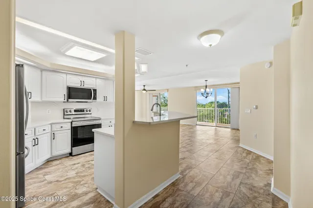 a kitchen with stainless steel appliances a stove sink and microwave