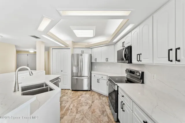 a kitchen with sink cabinets and wooden floor