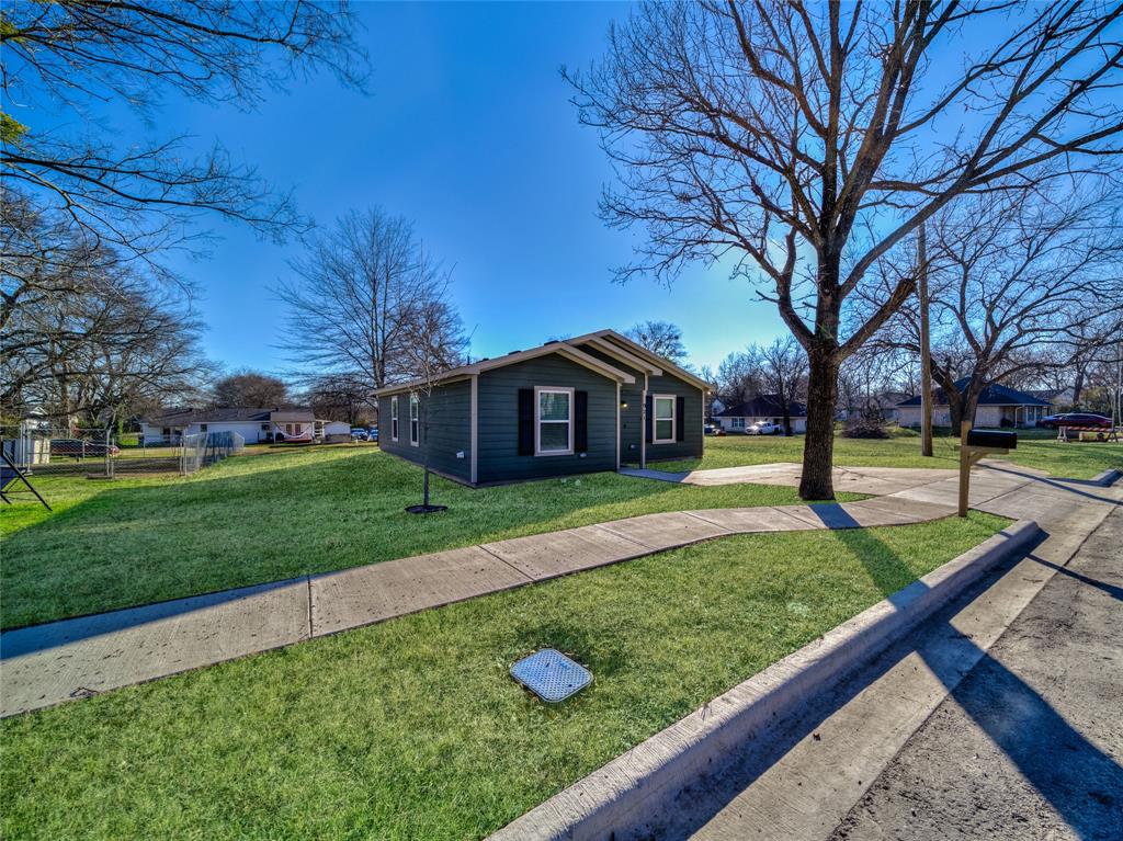 921 West 9th Street Bonham, TX 75418 - Photo 2 of 24 a front view of a house with garden