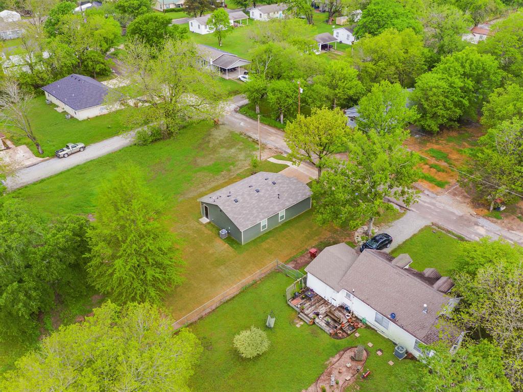 921 West 9th Street Bonham, TX 75418 - Photo 21 of 24 an aerial view of a house with a yard swimming pool outdoor seating and yard
