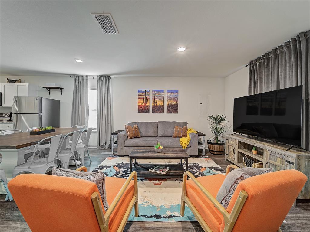 921 West 9th Street Bonham, TX 75418 - Photo 3 of 24 a living room with furniture and a flat screen tv