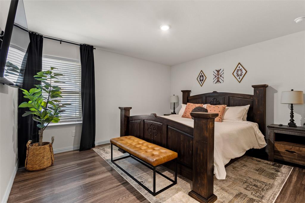 921 West 9th Street Bonham, TX 75418 - Photo 7 of 24 a bedroom with a bed and a potted plant