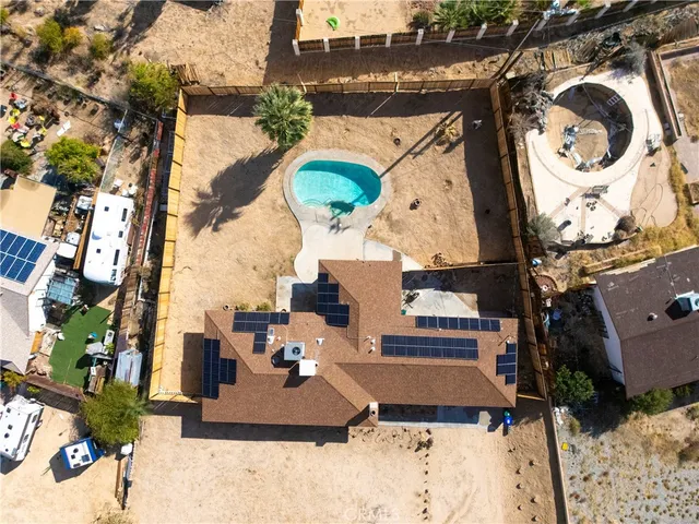 an aerial view of a house with a yard and sitting area