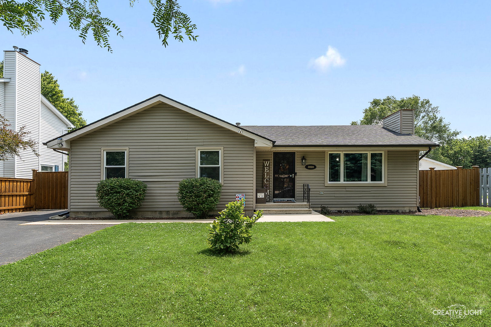 a front view of house with yard and green space