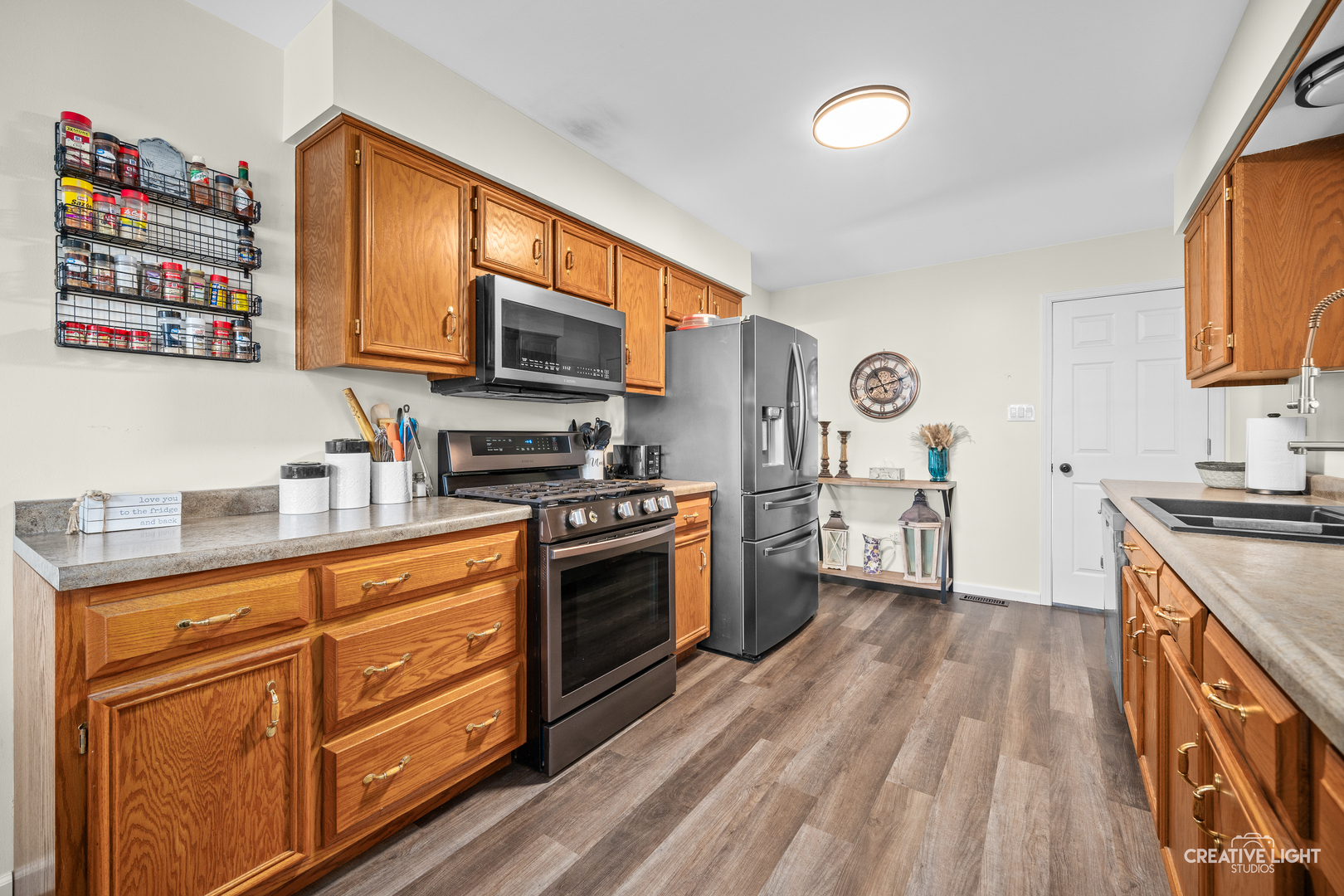 3000 Art Schultz Drive Plainfield, IL 60586 - Photo 7 of 18 a kitchen with stainless steel appliances granite countertop a stove a sink and a refrigerator
