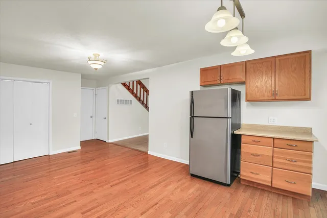 a kitchen with a refrigerator cabinet and a sink