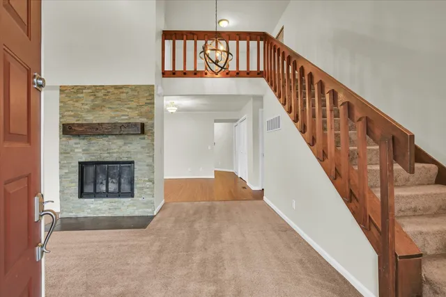 a view of a livingroom with wooden floor and a fireplace