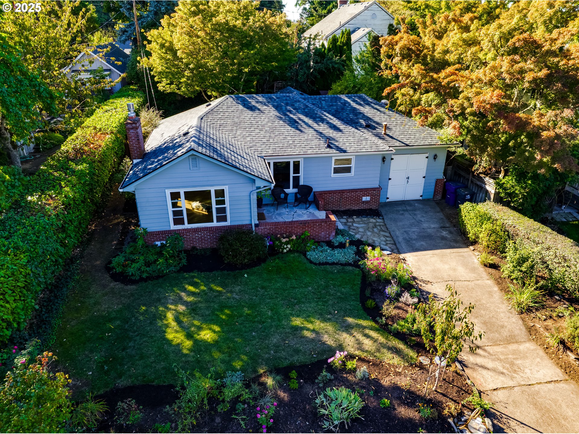 2140 Monroe Street Eugene, OR 97405 - Photo 2 of 35 a aerial view of a house with table and chairs under an umbrella