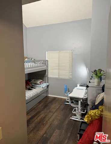 a bedroom with furniture and a lamp